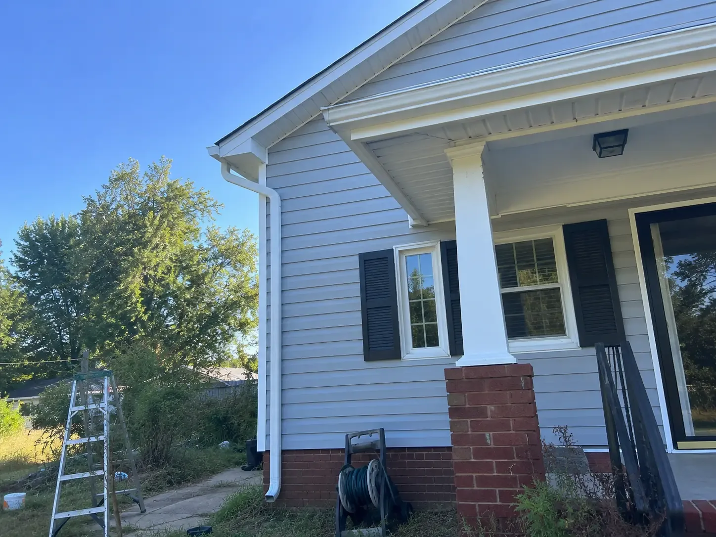 Clean siding, soffits, gutters, and porch trim on a Virginia home