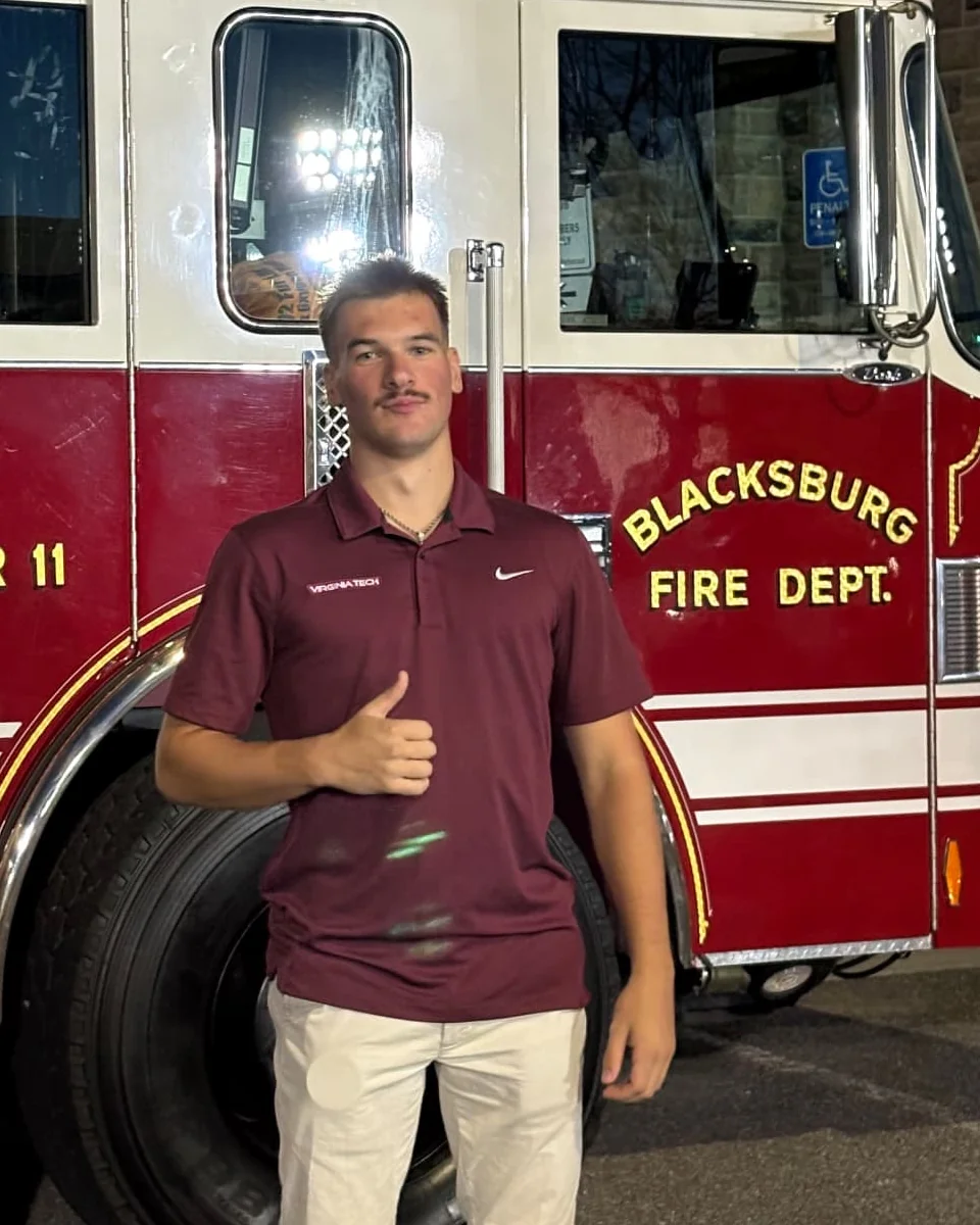 Exterior Solutions owner standing in front of a Blacksburg Fire Department ladder truck